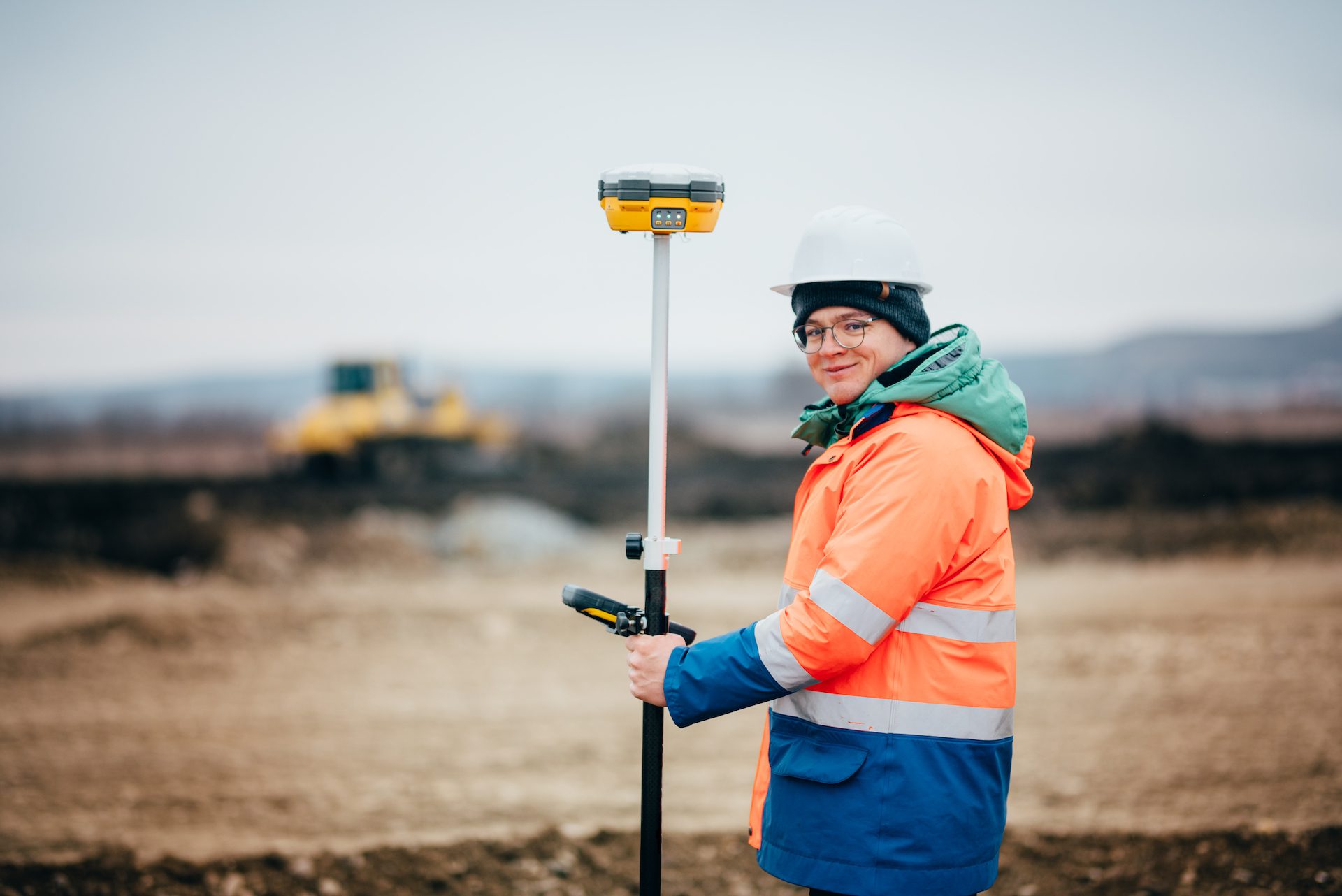 Surveyor engineer working on highway construction site, working with theodolite and gps system