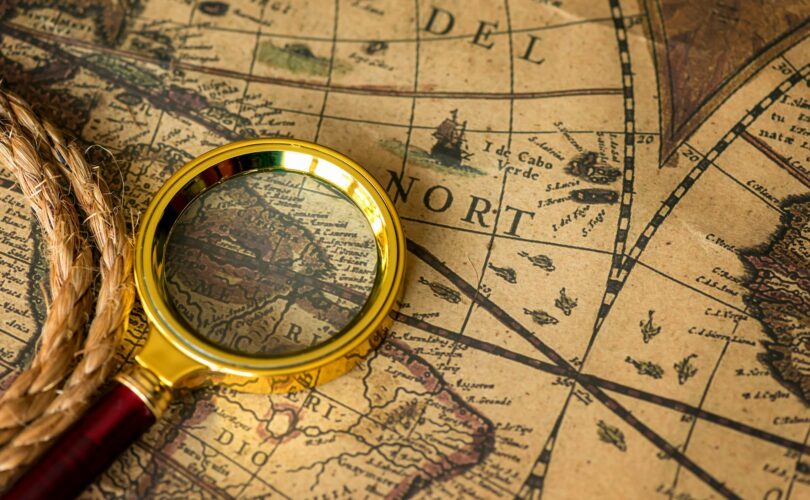 Retro magnifier and rope with old map closeup