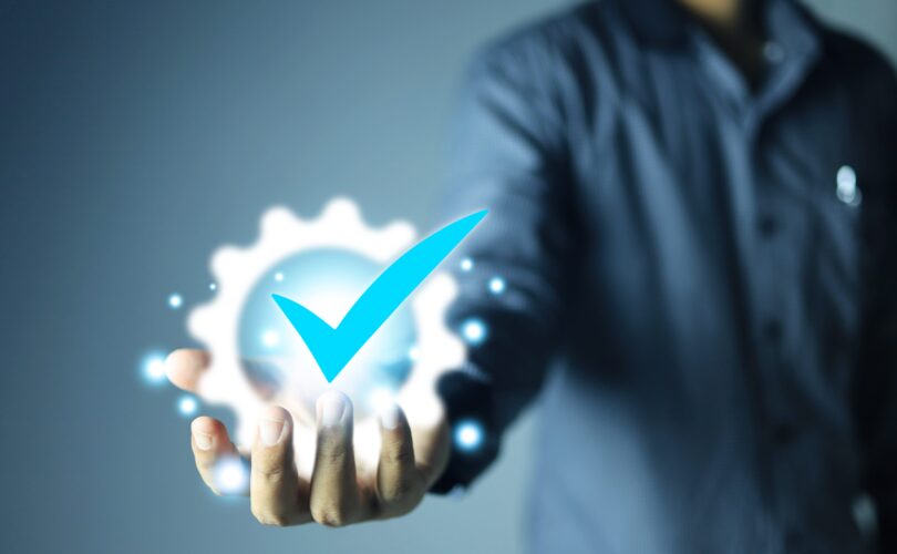 Hand shows the sign of the top service Quality assurance, Guarantee, Standards, ISO certification and standardization concept.